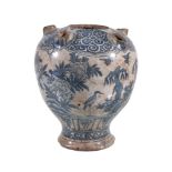 A Safavid blue and white pottery tulip vase, Persia, 17th Century, of baluster form with a central