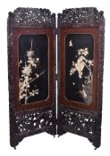 Y A Japanese Two-Fold screen, elaborately carved with squirrel amongst grapes, the lower register