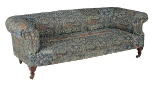 A mahogany and upholstered sofa, covered with original Morris & Co. woven fabric, circa 1920, the