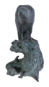A Japanese bronze figure of a bird of prey, the hunched avian perched atop a weathered tree stump