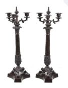 A pair of patinated metal three light candelabra in Restauration style, second half 20th century,