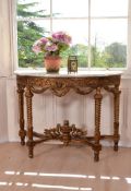 A carved giltwood and marble topped console table, late 19th century, of semi-elliptical outline,