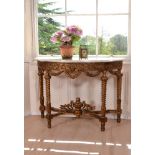 A carved giltwood and marble topped console table, late 19th century, of semi-elliptical outline,