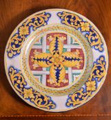 A modern Italian Maiolica charger, typically decorated with foliate arabesques in shades of red,