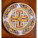 A modern Italian Maiolica charger, typically decorated with foliate arabesques in shades of red,