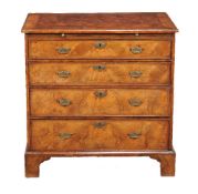 A George II walnut and feather banded bachelor’s chest of drawers, circa 1740, with brushing