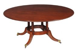 A mahogany circular dining table in 19th century style, 20th century, stamped with a roundel and