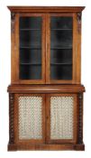 Y An early Victorian rosewood cabinet bookcase, circa 1850, with a pair of glazed doors enclosing