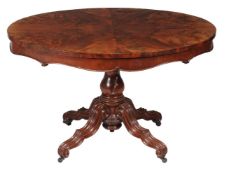 A Victorian mahogany oval centre table, circa 1870, the radial veneered top above carved and
