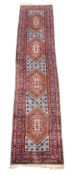 A Hamadan runner, decorated with lozenge medallions in tones of burnt orange, sky blue and