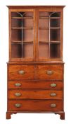 A George III mahogany and line inlaid secretaire bookcase, circa 1780, the glazed doors enclosing