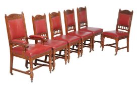A set of twelve oak and red leather upholstered dining chairs, circa 1900, to include a pair of