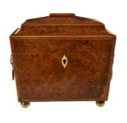 Y A Regency yew and burr yew wood tea caddy, circa 1815, of sarcophagus form, the hinged cover and