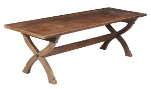 An oak refectory table, the plank top with end cleats above X-frame end supports united by a central