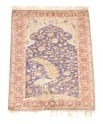 A Tabriz silk prayer rug, the mihrab above a floral decorated scene incorporating a stork, within