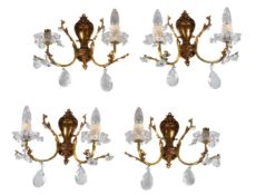 A set of four gilt metal and moulded glass twin light wall appliques, second half 20th century,