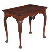 A mahogany silver table in George III Irish style, 19th century, the dished top above shell motifs
