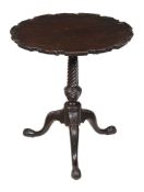 A George III carved mahogany tripod table, circa 1770, the hinged circular shaped top with carved '