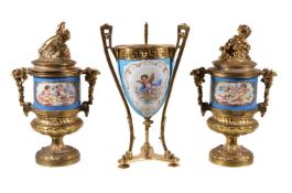 A pair of Sevres-style gilt-metal mounted pedestal urns and covers, circa 1900, typically