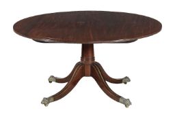 A George IV mahogany and brass strung breakfast table, circa 1825, the circular tilt top above