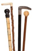 Y Four various walking sticks, the first Chinese sectional bone, early 20th century, with a hardwood