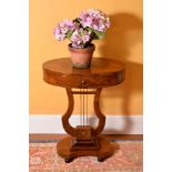 A walnut oval occasional table in Empire style, late 19th century, the quarter veneered top above