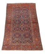 A Fereghan kelleh or gallery carpet, the polychrome decorated navy field within a madder border,