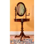 A mahogany dressing stand, mid-19th century, the oval mirror on turned sconce supports above the