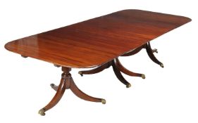 A mahogany triple pedestal dining table in Regency style, 20th century, with two additional leaf