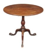 A George III mahogany tripod table, circa 1780, the single plank top above baluster pillar and