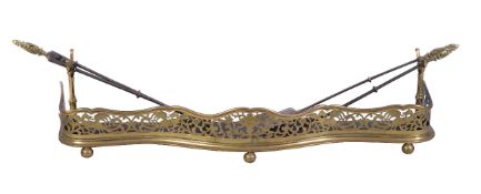 A pierced brass and sheet iron mounted fender, second quarter 19th century, the serpentine front