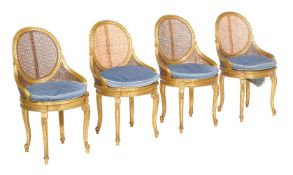 A set of four giltwood salon chairs, 20th century, each with removable blue swab cushion