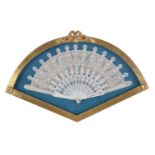 A Regency bone fan, decorated with fronds and sprays, in a giltwood and glazed display case, the fan