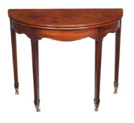 A George III mahogany folding tea table, circa 1790, of demi-lune outline, 74cm high, 94cm wide,