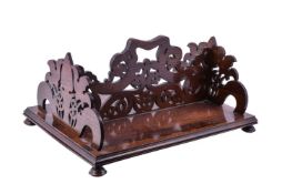 Y A George IV carved rosewood book carrier, circa 1825, the central division with openwork foliate