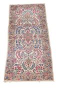 A Kirman rug, approximately 277 x 111cm