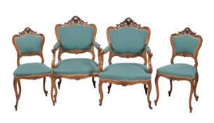 A set of four French carved walnut and upholstered salon chairs, comprising a pair of armchairs,
