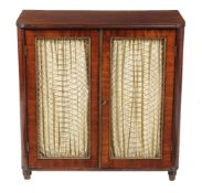 A Regency mahogany and gilt metal mounted side cabinet, circa 1815, the wirework panelled doors