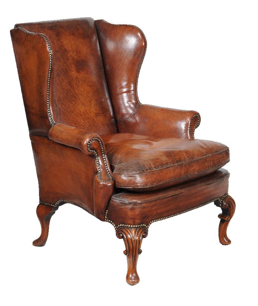 A mahogany and brown leather upholstered wing armchair, in George II style, 20th century, 104cm
