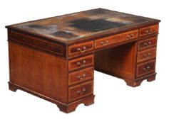 An Edwardian mahogany and satinwood partner's pedestal desk, circa 1900, the leather insert top