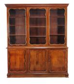 A French mahogany and parcel gilt cabinet bookcase, 20th century, the glazed doors enclosing
