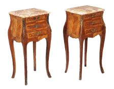 Y A pair of walnut and tulipwood bedside tables, early 20th century, each with three drawers with