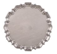 A late Victorian silver shaped circular salver by T Bradbury, London 1899, with a raised moulded