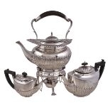 An Edwardian silver oval baluster kettle on stand by William Hutton & Sons Ltd., London 1902, the