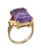 An 18 carat gold amethyst ring, the rectangular fancy cut amethyst in a four claw setting, stamped