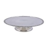 A silver circular pedestal dish by Wakely & Wheeler, London 1932, with a Celtic border and on a