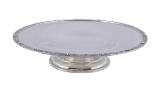 A silver circular pedestal dish by Wakely & Wheeler, London 1932, with a Celtic border and on a