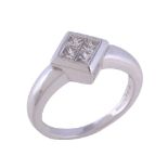 A diamond ring, the square panel set with four square cut diamonds, approximately 0.25 carats total,