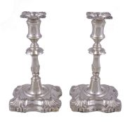 A pair of Edwardian silver taper sticks in early George III style by William Hutton & Sons Ltd.,