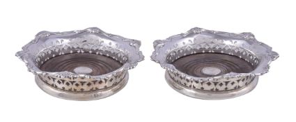 A pair of Edwardian silver shaped circular coasters, one marked George Fox, London 1902, the other